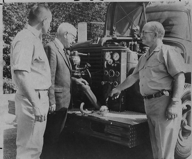 From the Archives: Chief Henry Morris & New E3.  From The Westerly Sun 9/21/71.  Caption reads: &quot;Dunn's Corners firemen showed their newest piece of rolling apparatus Sunday in an open house at Station 2 at Quonochontaug.  The truck, purchased at a cost of $18,000, was delivered to the department earlier this month.  Above, Fire Chief Henry M. Morris (right) expains the vehicle's operation to Alfred Merker (center) while Robert H. Hutchins, second assistant chief watches.&quot;